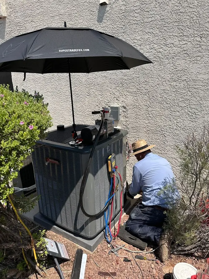 HVAC technician performing outdoor AC maintenance in Pasadena